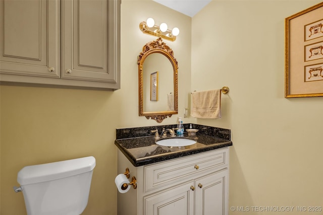bathroom featuring toilet and vanity