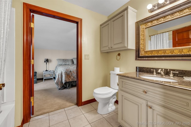 bathroom featuring tile patterned floors, toilet, curtained shower, vanity, and baseboards