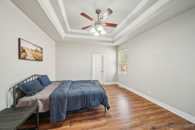 12916 E 181st St S, Bixby, OK 74008 - bedroom featuring wood finished floors, a tray ceiling, crown molding, baseboards, and a ceiling fan