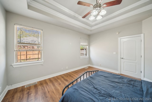 12916 E 181st St S, Bixby, OK 74008 - bedroom with crown molding, a tray ceiling, wood finished floors, baseboards, and ceiling fan