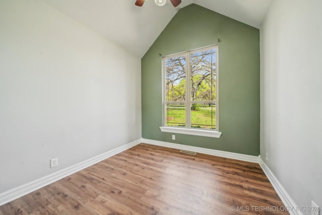 12916 E 181st St S, Bixby, OK 74008 - empty room featuring a ceiling fan, vaulted ceiling, wood finished floors, and baseboards