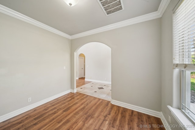 12916 E 181st St S, Bixby, OK 74008 - unfurnished room featuring arched walkways, crown molding, baseboards, and wood finished floors