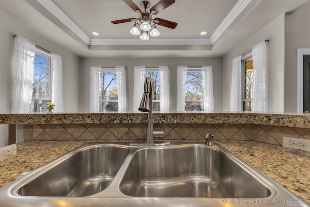 12916 E 181st St S, Bixby, OK 74008 - kitchen view of a sink, ceiling fan, a raised ceiling, ornamental molding, and light stone counters