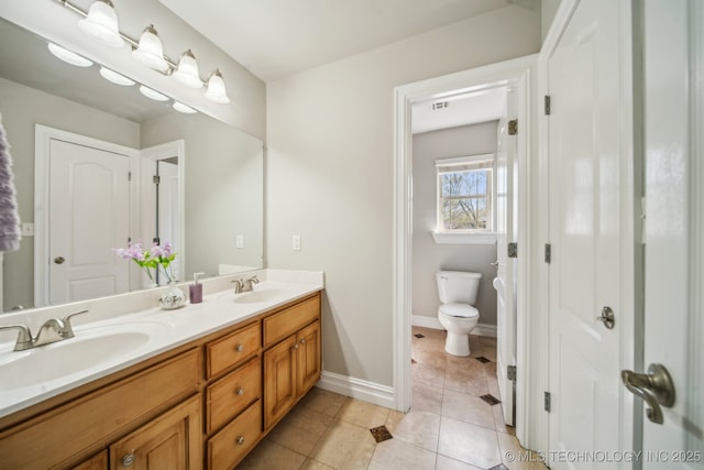 12916 E 181st St S, Bixby, OK 74008 - full bathroom featuring toilet, tile patterned floors, double vanity, and baseboards