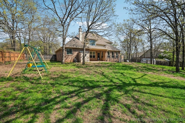 12916 E 181st St S, Bixby, OK 74008 - rear view of property with a playground, a chimney, and brick siding