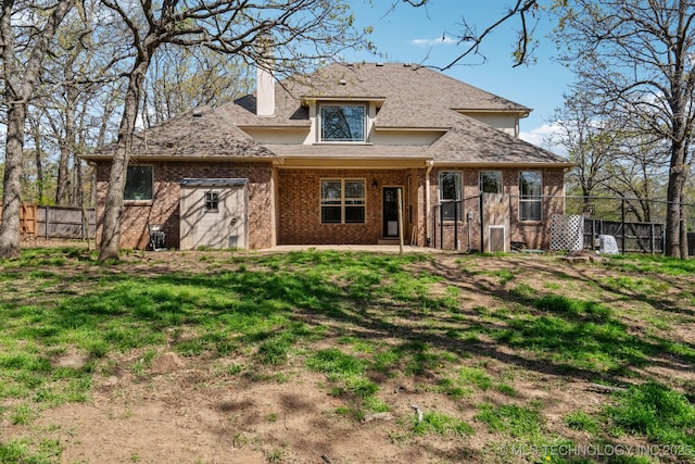12916 E 181st St S, Bixby, OK 74008 - view of front facade with fence, brick siding, and a chimney