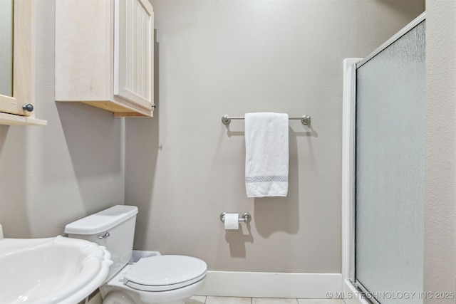 447560 Angler Way, Vinita, OK 74301 - full bathroom with a stall shower, tile patterned floors, toilet, a sink, and baseboards