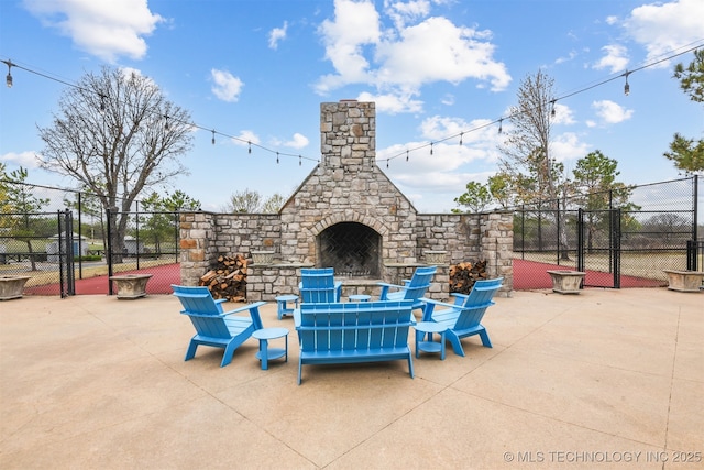 447560 Angler Way, Vinita, OK 74301 - view of patio / terrace with a gate, an outdoor stone fireplace, and fence