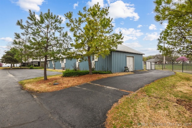 447560 Angler Way, Vinita, OK 74301 - view of front of property with an outbuilding, fence, metal roof, board and batten siding, and a garage