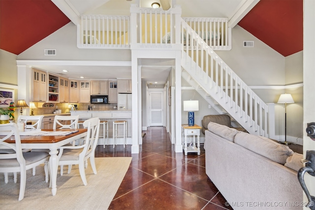 447560 Angler Way, Vinita, OK 74301 - dining room with beam ceiling, high vaulted ceiling, stairs, and visible vents