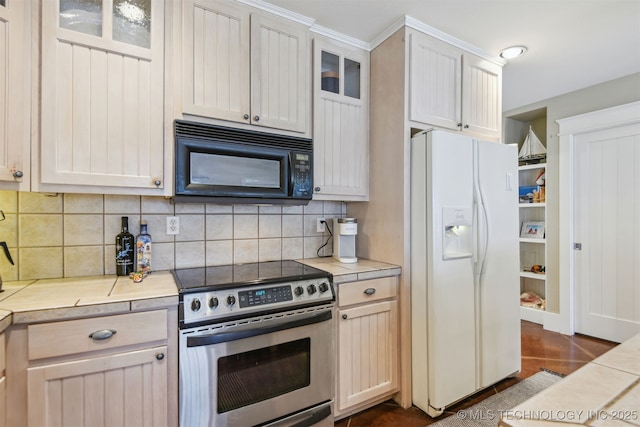 447560 Angler Way, Vinita, OK 74301 - kitchen featuring light countertops, backsplash, black microwave, white refrigerator with ice dispenser, and stainless steel electric stove