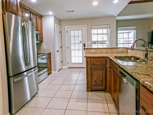 kitchen with recessed lighting, light tile patterned floors, stainless steel appliances, a sink, and visible vents
