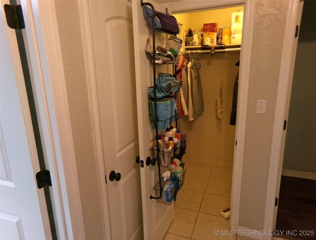 interior space featuring baseboards and tile patterned flooring