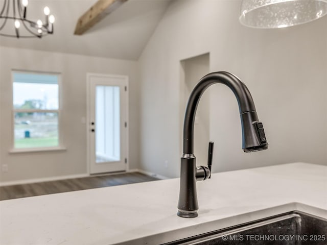 13406 E 124th St, Collinsville, OK 74021 - interior details with an inviting chandelier, light countertops, hanging light fixtures, and wood finished floors