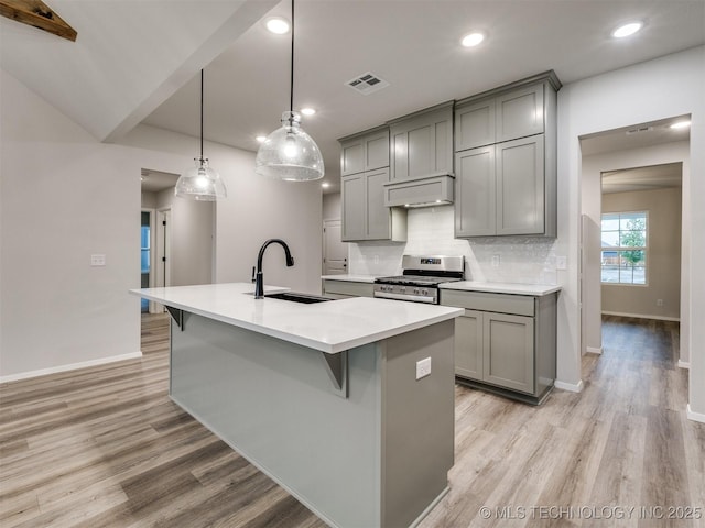 13406 E 124th St, Collinsville, OK 74021 - kitchen featuring decorative backsplash, gas stove, a sink, exhaust hood, and gray cabinets