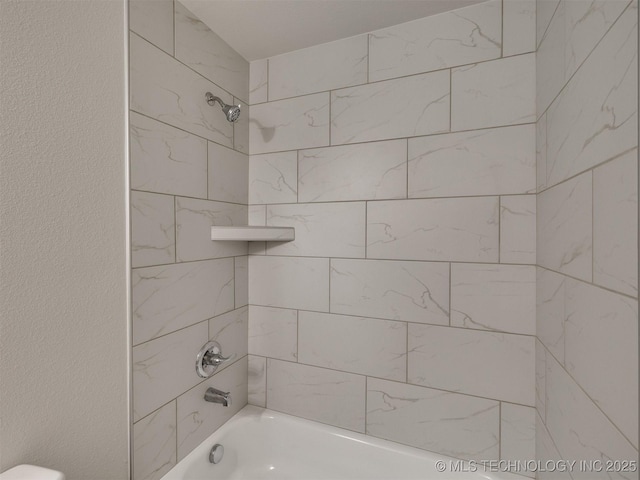 13406 E 124th St, Collinsville, OK 74021 - bathroom featuring shower / tub combination and a textured wall