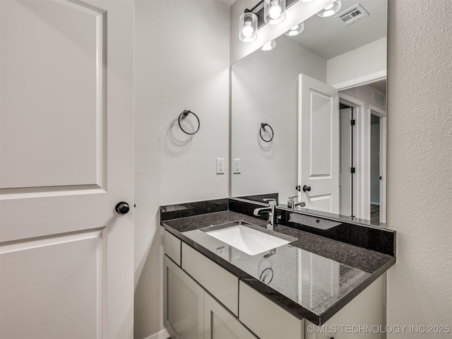 13406 E 124th St, Collinsville, OK 74021 - bathroom with a textured wall, visible vents, and vanity