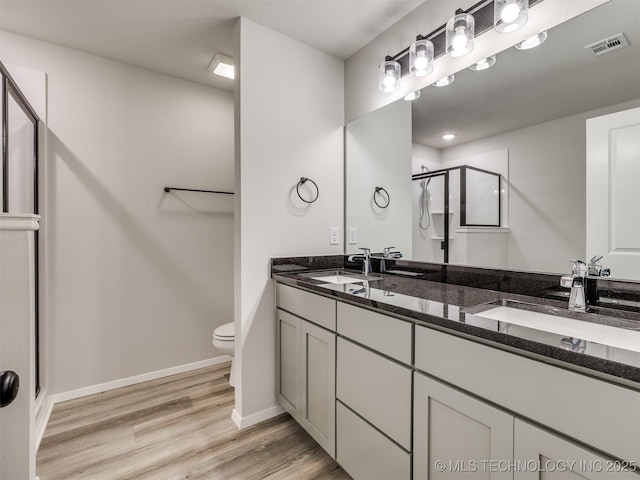 13406 E 124th St, Collinsville, OK 74021 - bathroom featuring wood finished floors, a sink, a stall shower, and visible vents