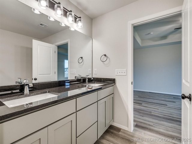 13406 E 124th St, Collinsville, OK 74021 - full bathroom with baseboards, visible vents, wood finished floors, and a sink