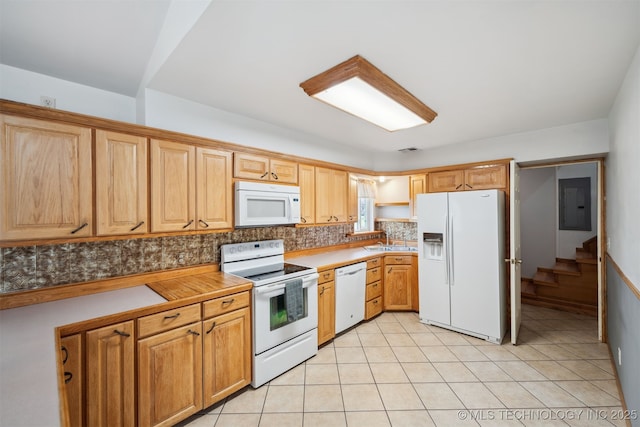 kitchen with light tile patterned flooring, a sink, tasteful backsplash, white appliances, and visible vents