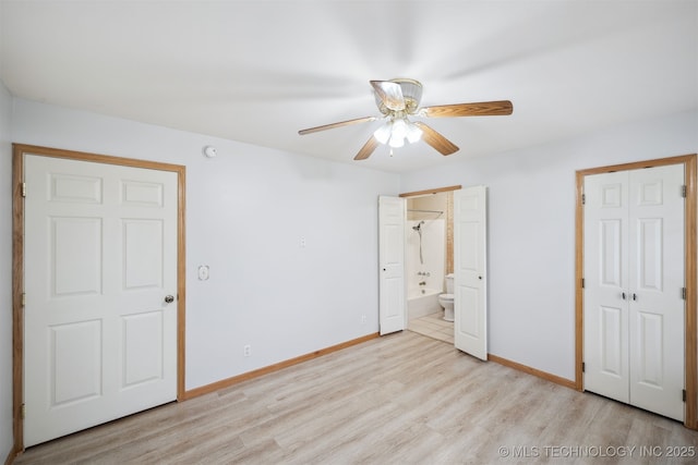 unfurnished bedroom with a ceiling fan, light wood-style flooring, connected bathroom, and baseboards