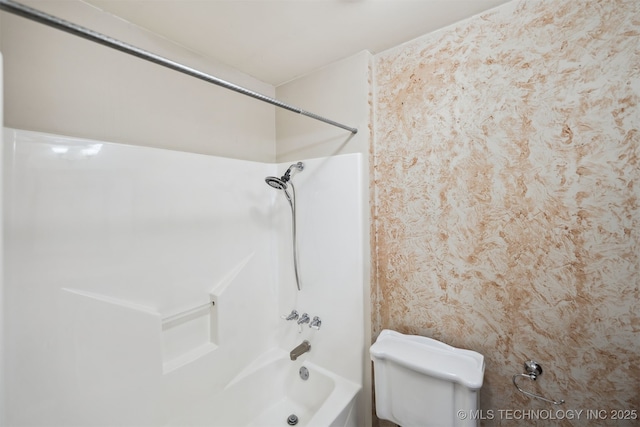 bathroom featuring toilet and bathing tub / shower combination