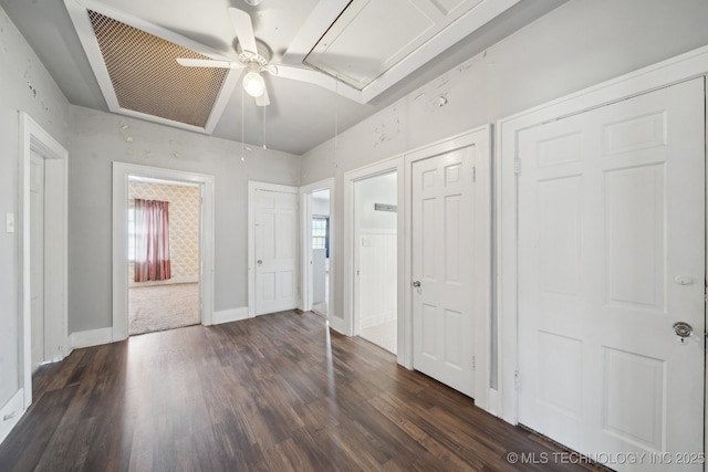 unfurnished bedroom featuring dark wood finished floors, baseboards, and ceiling fan