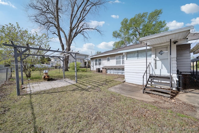 view of yard featuring fence and entry steps