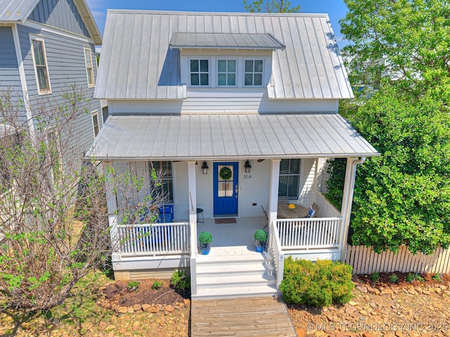 35 Boardwalk St Unit A, Carlton Landing, OK 74432 - view of front of house with a standing seam roof, covered porch, and a metal roof