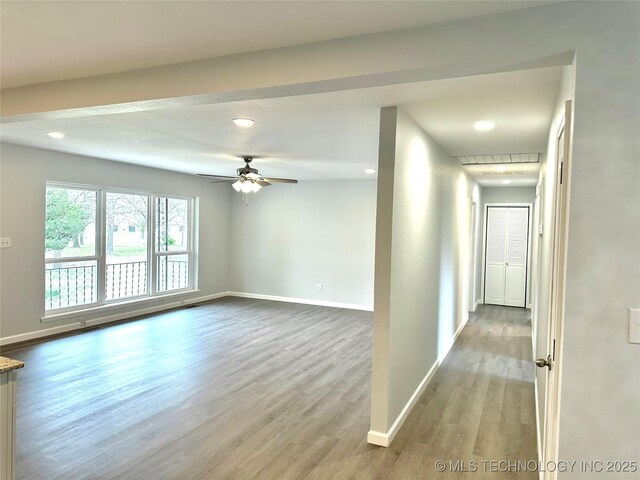 unfurnished room with recessed lighting, a ceiling fan, wood finished floors, and baseboards