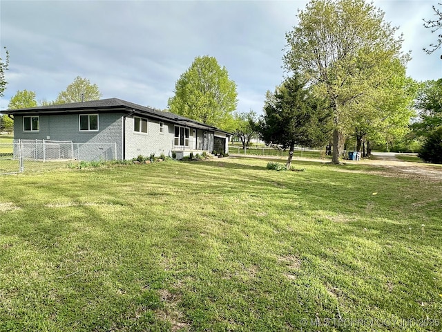 view of yard with fence and a garage