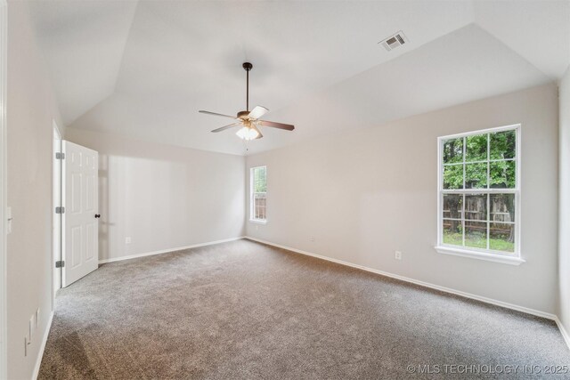unfurnished room featuring carpet flooring, a ceiling fan, baseboards, lofted ceiling, and visible vents