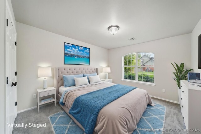 carpeted bedroom with baseboards and visible vents