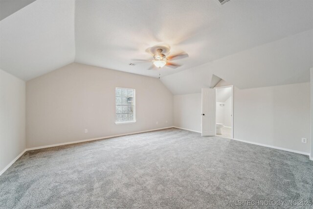 bonus room with carpet flooring, ceiling fan, baseboards, and lofted ceiling
