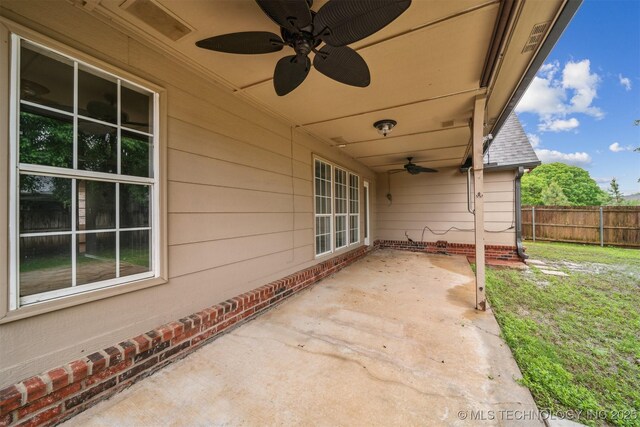 view of patio featuring fence and a ceiling fan