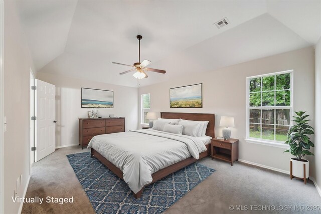 carpeted bedroom featuring baseboards, ceiling fan, vaulted ceiling, and visible vents