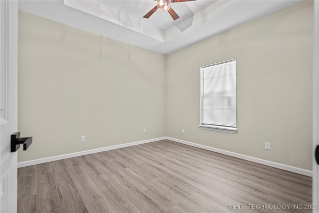 809 H NW, Ardmore, OK 73401 - unfurnished room with a raised ceiling, wood finished floors, and ceiling fan