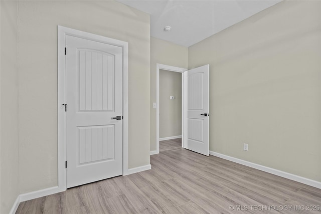 809 H NW, Ardmore, OK 73401 - unfurnished bedroom featuring wood finished floors and baseboards