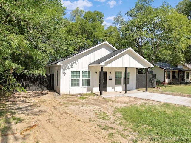 809 H NW, Ardmore, OK 73401 - view of front of home with board and batten siding and concrete driveway