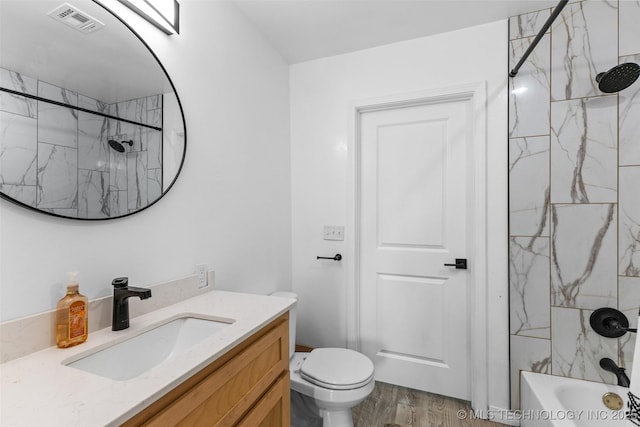 900 S Johnston, Ada, OK 74820 - full bath featuring wood finished floors, vanity, toilet, and shower / washtub combination