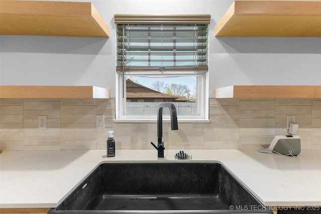 900 S Johnston, Ada, OK 74820 - kitchen featuring a sink, decorative backsplash, and light countertops