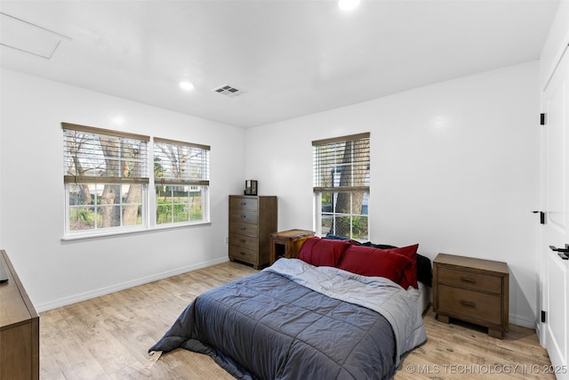 900 S Johnston, Ada, OK 74820 - bedroom with multiple windows, light wood-style flooring, and baseboards