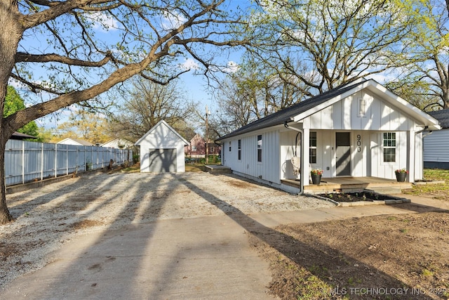 900 S Johnston, Ada, OK 74820 - view of front of house featuring covered porch, board and batten siding, driveway, and a detached garage