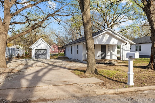 900 S Johnston, Ada, OK 74820 - view of front of home featuring board and batten siding, covered porch, a garage, an outbuilding, and driveway