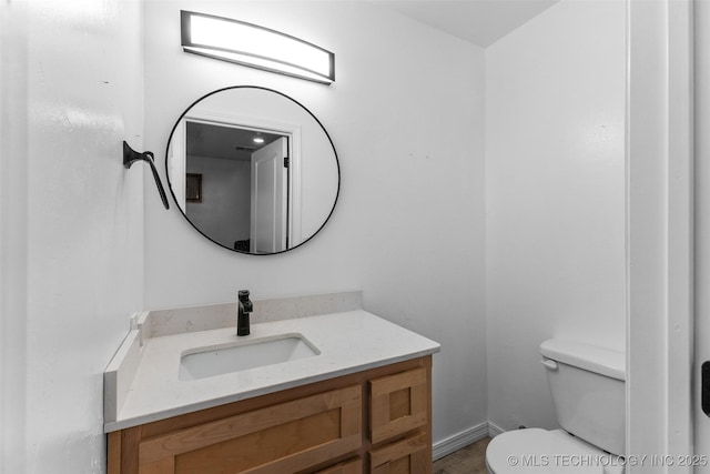 900 S Johnston, Ada, OK 74820 - bathroom with toilet, vanity, and baseboards