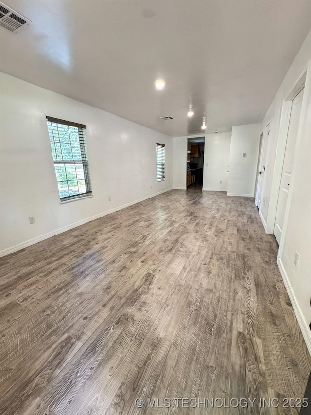 900 S Johnston, Ada, OK 74820 - unfurnished living room featuring wood finished floors and baseboards