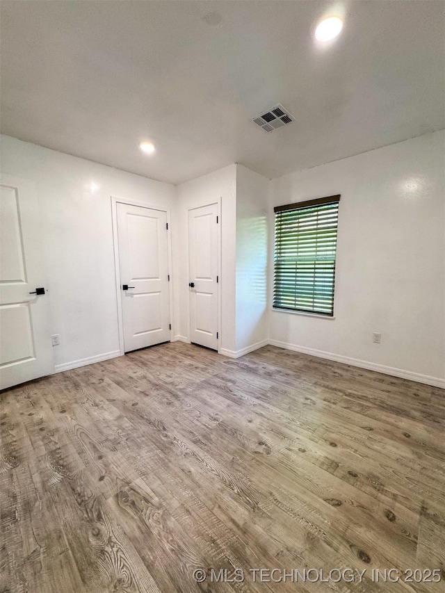 900 S Johnston, Ada, OK 74820 - spare room with wood finished floors, baseboards, and recessed lighting