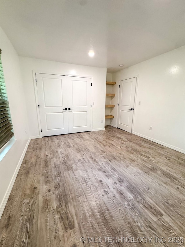 900 S Johnston, Ada, OK 74820 - unfurnished bedroom featuring wood finished floors, baseboards, recessed lighting, and a closet