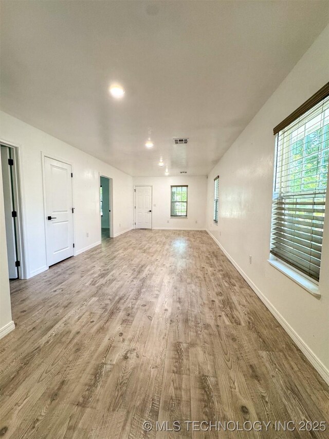 900 S Johnston, Ada, OK 74820 - unfurnished living room featuring wood finished floors and baseboards