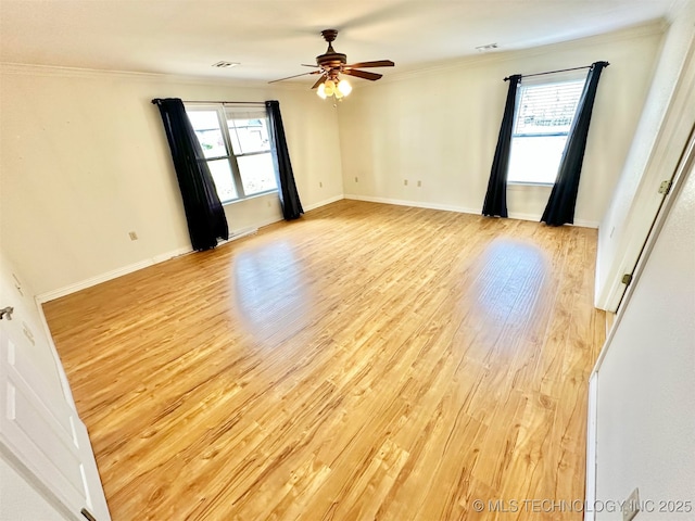 unfurnished room with light wood-style floors, ceiling fan, ornamental molding, and a wealth of natural light